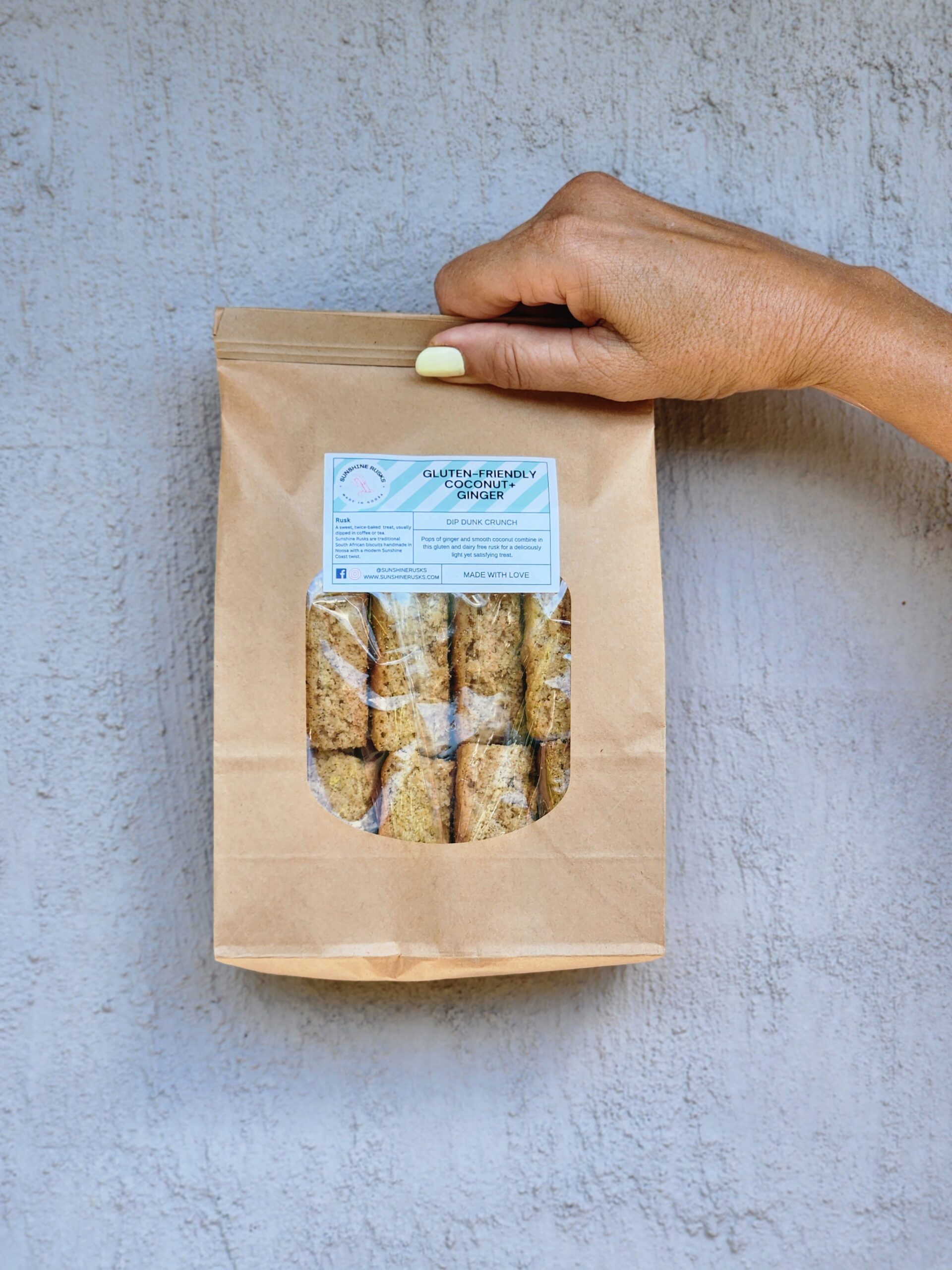 Hand holding a 500gm bacg of rusks